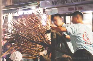 Inserting incense into the dragon clay body